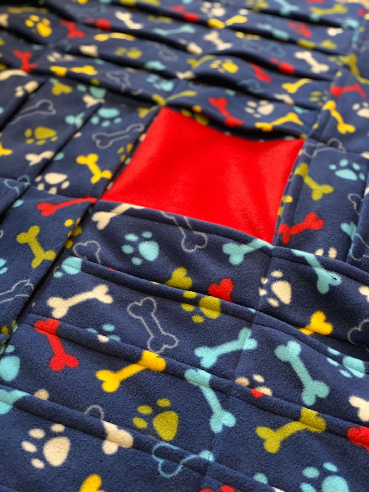 Our PickPocket foraging blanket lies flat on the floor and has sixty pockets perpendicular to each other for your dog to search in for treats. It can also double up as your dog’s dinner bowl and also a bed! The blanket offers a gentle non-stress foraging